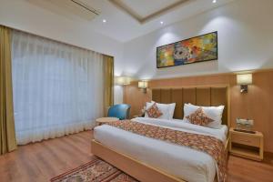 a hotel room with a large bed and a window at hotel Linda Grand Near Delhi Airport, A Block road no 6 street No 12 Mahipalpur New Delhi in New Delhi