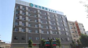 a large gray building with a sign on it at City Comfort Inn Yunfu Luoding Triumph Plaza in Shuangdongjieban