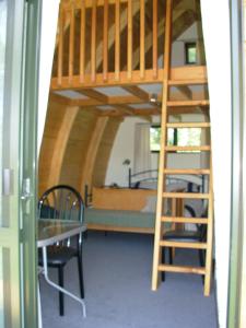 a room with a bunk bed and a ladder at Wetland View Park in Anatori