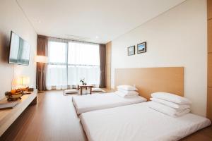 Postel nebo postele na pokoji v ubytování YOUUS Hotel