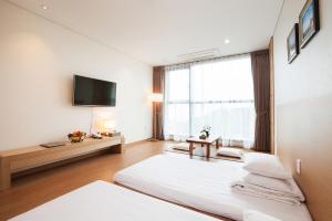 Postel nebo postele na pokoji v ubytování YOUUS Hotel