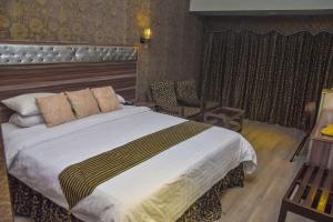 a bedroom with a large bed in a room at Faran Hotel in Karachi