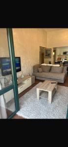 a living room with a couch and a coffee table at Apartman Herceg Novi Capital in Kamenari