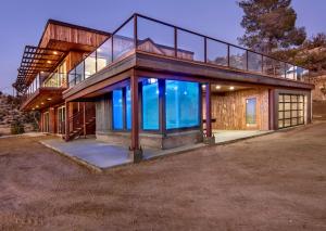 a large house with a large glass facade at Mountain Views, Pool, Spa & Serenity Stargate in Yucca Valley