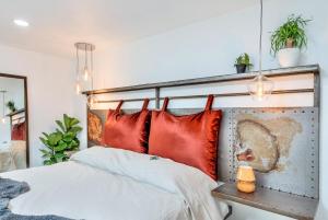 a bedroom with a bed with red pillows at Mountain Views, Pool, Spa & Serenity Stargate in Yucca Valley +23 photos