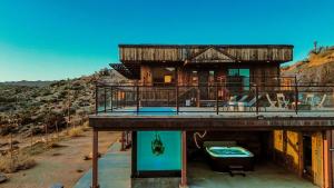 a house with a deck with a hot tub on top at Mountain Views, Pool, Spa & Serenity Stargate in Yucca Valley