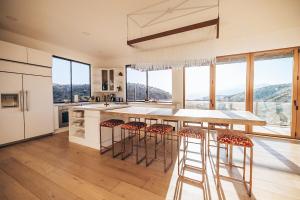 a kitchen with a large island with bar stools at Mountain Views, Pool, Spa & Serenity Stargate in Yucca Valley