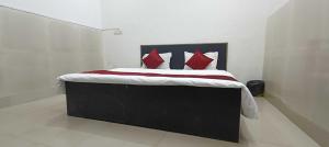 a bedroom with a large bed with red pillows at Hotel O DP Palace in LKO