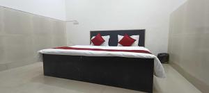 a bedroom with a large bed with red pillows at Hotel O DP Palace in LKO