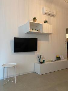 un salon avec une télévision sur un mur blanc dans l'établissement Nala & Leo Seaview Apartment, à Lerici