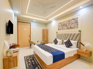 a bedroom with a large bed in a room at Hotel Aero Home in Behror