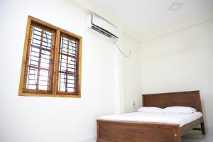 Ένα ή περισσότερα κρεβάτια σε δωμάτιο στο Naren Guest House