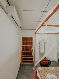 a room with a bed with a tent in it at Hiriketiya Lima Homestay in Dickwella +11 photos