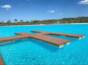 a swimming pool in the middle of the blue water at 2 Bed at the Blyde in Pretoria