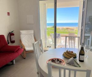 a living room with a table with a plate of bananas on it at IL GIARDINO DAMARE in Donnalucata