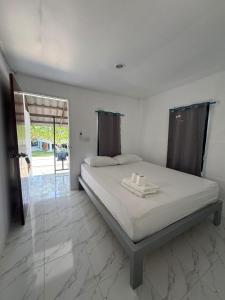 Ένα ή περισσότερα κρεβάτια σε δωμάτιο στο The Beach Bungalow