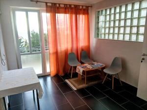 a room with two chairs and a table and windows at Apartman Petra in Senj
