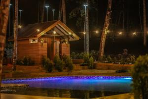 a house with a swimming pool at night at SkyTree Glamping - Huda's Haven in Batang Kali