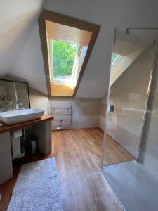 un bagno con doccia, lavandino e finestra di Bieszczadzki Zakątek a Ustrzyki Dolne