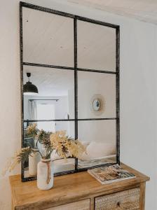 a mirror sitting on top of a wooden table at La Source in Oppedette