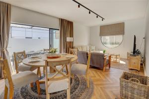 Un comedor y una sala de estar con mesa y sillas. en Timber and Tides, en George