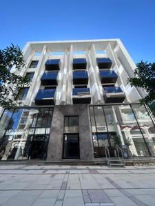 a large building with windows on the side of it at Raam Luxury Suites in Larnaka