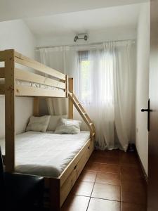 a bedroom with a bunk bed and a window at Casa mémé in Marco de Canavezes