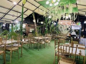 a banquet hall with tables and chairs and plants at Ecostay Panglao Resort Hotel in Panglao Island +109 photos