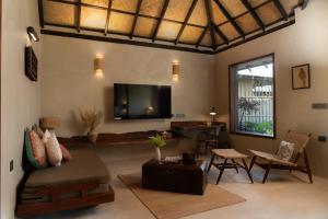 a living room with a couch and a tv at Shambhala in Bhopal +135 photos