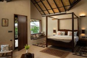 a bedroom with a canopy bed in a room at Shambhala in Bhopal