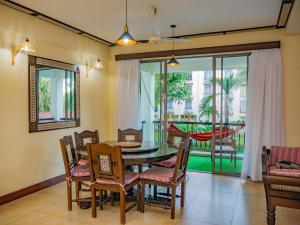 a dining room with a table and chairs at AfroHaki Homes in Mombasa