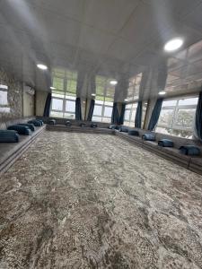 a large room with couches and a carpeted floor at Evan Rest House in Salalah