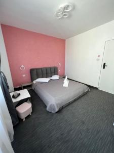 a bedroom with a large bed and a pink wall at Hotel AmA in Constanţa