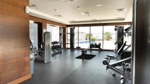 a gym with treadmills and machines in a building at Sea View Modern 2BHK Apartment with Balcony in Ras al Khaimah