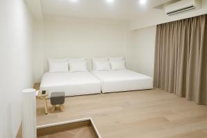 Postel nebo postele na pokoji v ubytování 冬山好朋友家 D-ong S-han good friend B&B