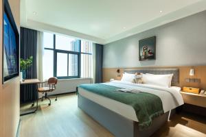 Postel nebo postele na pokoji v ubytování Yangji Yueya Hotel + 6 fotografií