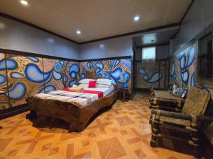 a bedroom with a bed and a painting on the wall at Islandfront El Nido in El Nido