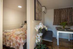 a bedroom with a bed and a desk and a table with a chair at Seaview Beach Camp Maslina in Biograd na Moru