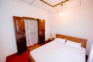 Ένα ή περισσότερα κρεβάτια σε δωμάτιο στο Aurora පාට පාට