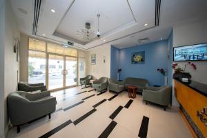 a waiting room with couches and chairs in a building at City Stay Grand Hotel Apartments - Al Barsha in Dubai
