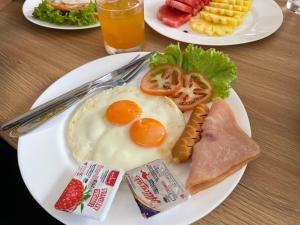 two plates of breakfast food on a table at Lanta Nesta Resort in Ko Lanta Yai