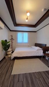 a bedroom with a large bed and a window at Stay jongno238 in Seoul