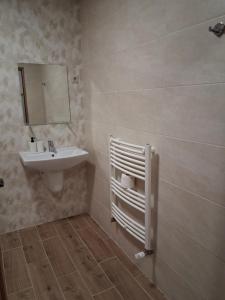 a bathroom with a sink and a mirror at Cervus Mirabilis in Covasna +25 photos