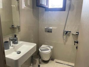 a bathroom with a sink and a toilet and a shower at SENSIMAR Rooms To Let in Ouranoupoli