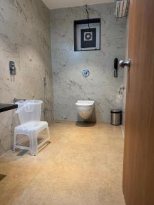 a bathroom with a toilet and a camera on the wall at Regenta Z Mahabaleshwar in Mahabaleshwar