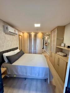 a bedroom with a large bed in a room at Bahamas 357 - Com Garagem in Águas Claras +5 photos