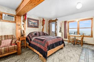 德卢斯The Inn On Gitche Gumee - The Wolves Den的房间里有一张床和一张书桌的卧室