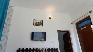 a room with two pictures on the wall and a door at Summer Guest House in Chauntrā