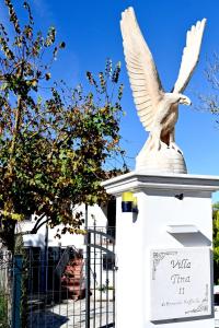 a statue of an eagle sitting on top of a building at B&B Resort Tina in Gesualdo