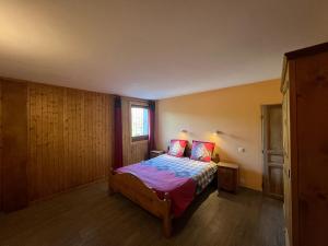 a bedroom with a bed and a window at La Maison des Coeurs in Lugrin